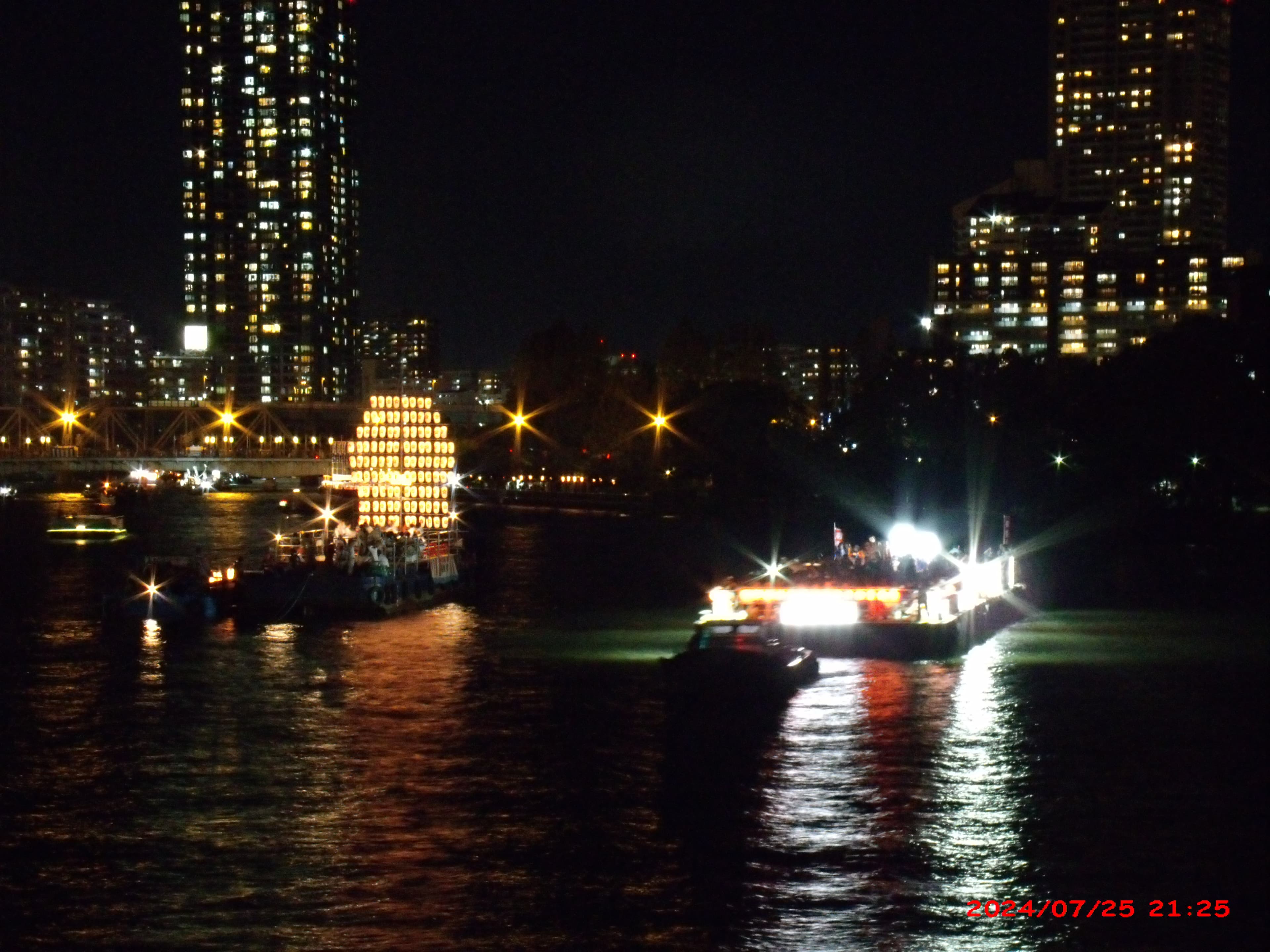 Festival boats on the river during Tenjin Matsuri in Osaka