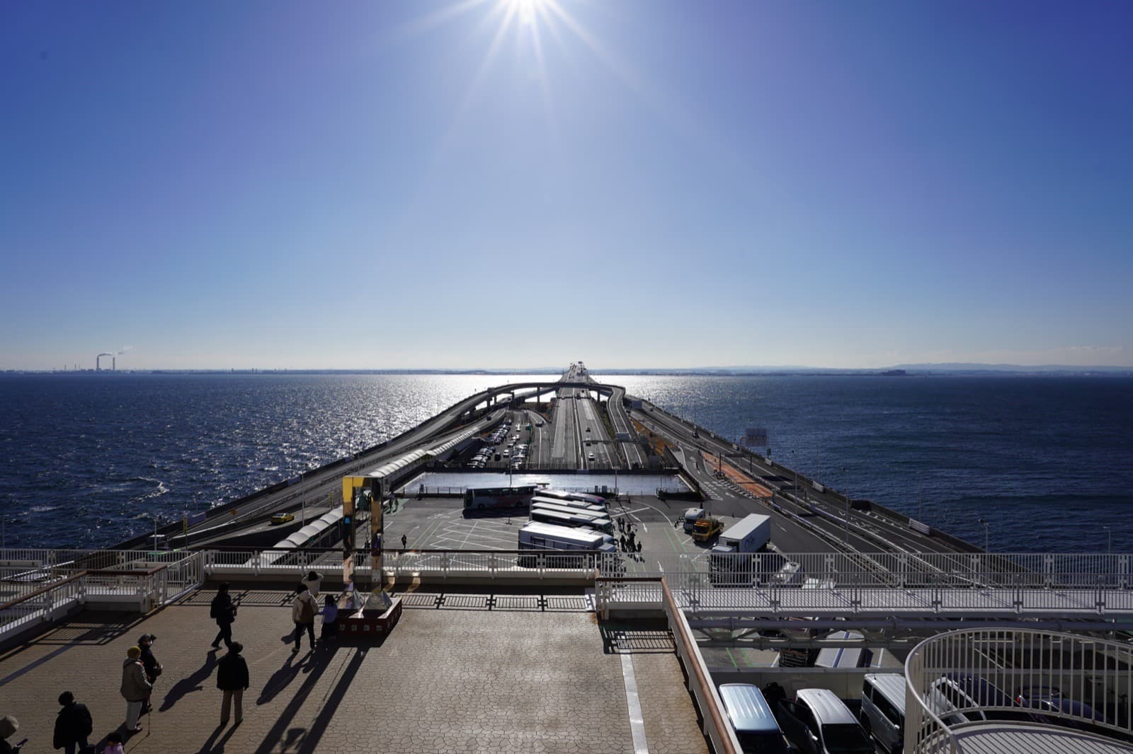 A wide Tokyo Bay bridge and sea route under a clear sky