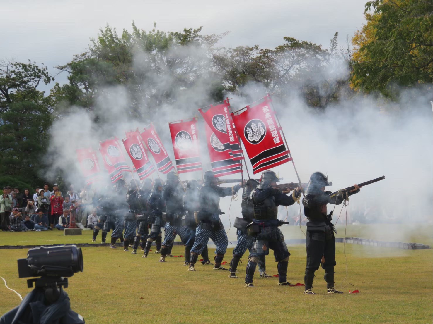 Matsumoto Castle Gun Corps firing matchlock guns in formation in 2019